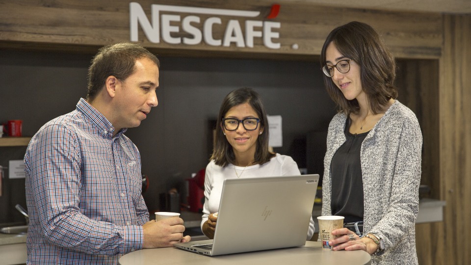 colleagues looking at the laptop